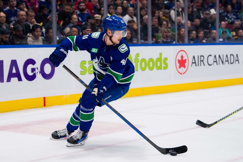 Dec 14, 2023; Vancouver, British Columbia, CAN; Vancouver Canucks forward Elias Pettersson (40) handles the puck against the Florida Panthers in the third period at Rogers Arena. Vancouver won 4-0. Mandatory Credit: Bob Frid-USA TODAY Sports