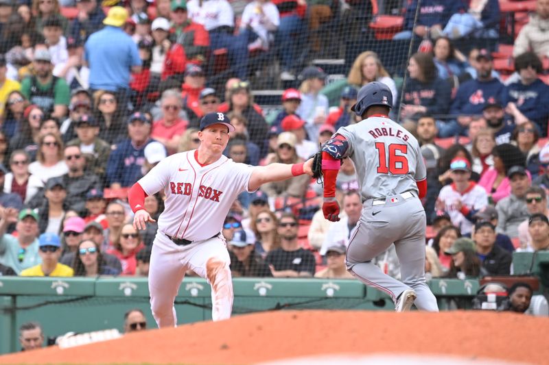 May 12, 2024; Boston, Massachusetts, USA;  Boston Red Sox first baseman Garrett Cooper (28) tags Washington Nationals center fielder Victor Robles (16) during the third inning at Fenway Park. Mandatory Credit: Eric Canha-USA TODAY Sports