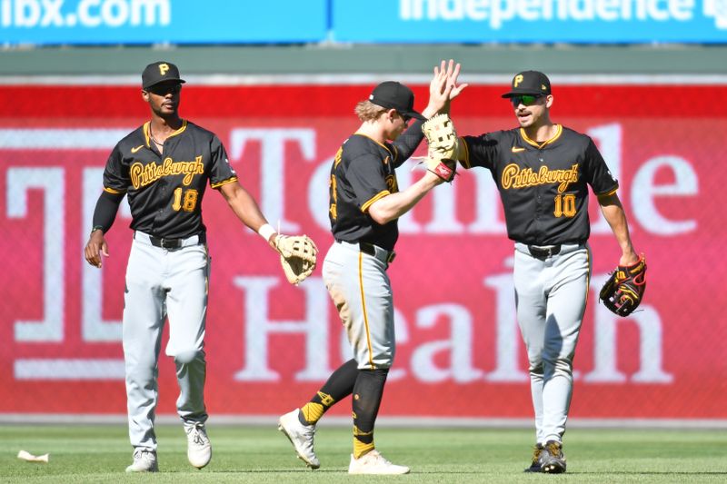 Apr 14, 2024; Philadelphia, Pennsylvania, USA;Pittsburgh Pirates outfielder Michael A. Taylor (18), outfielder Jack Suwinski (65) and outfielder Bryan Reynolds (10) celebrate win against the Philadelphia Phillies at Citizens Bank Park. Mandatory Credit: Eric Hartline-USA TODAY Sports