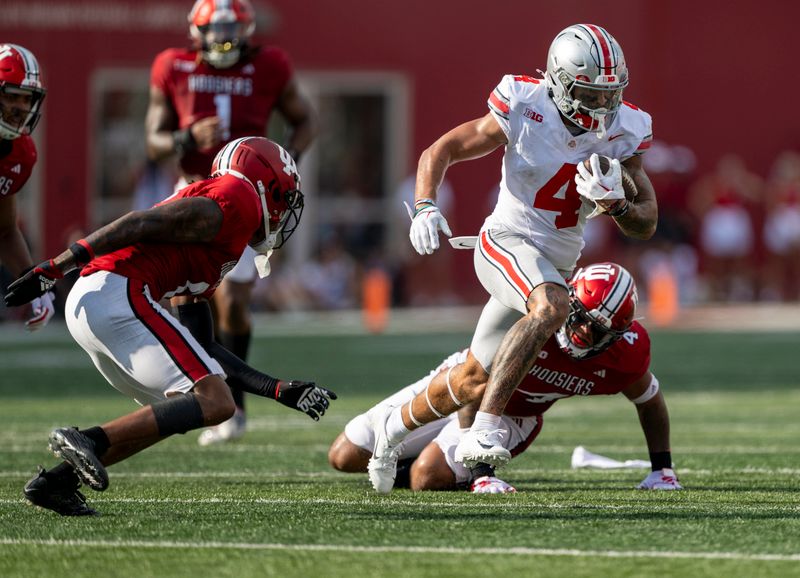 Sep 2, 2023; Bloomington, Indiana, USA; Ohio State Buckeyes wide receiver Julian Fleming (4) runs by two Indiana Hoosiers during the second half at Memorial Stadium. Mandatory Credit: Marc Lebryk-USA TODAY Sports