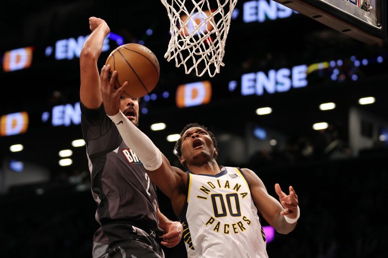 NEW YORK, NEW YORK - DECEMBER 04: Bennedict Mathurin #00 of the Indiana Pacers goes to the basket as Cameron Johnson #2 of the Brooklyn Nets defends during the first half at Barclays Center on December 04, 2024 in the Brooklyn borough of New York City. NOTE TO USER: User expressly acknowledges and agrees that, by downloading and or using this photograph, User is consenting to the terms and conditions of the Getty Images License Agreement. (Photo by Sarah Stier/Getty Images)