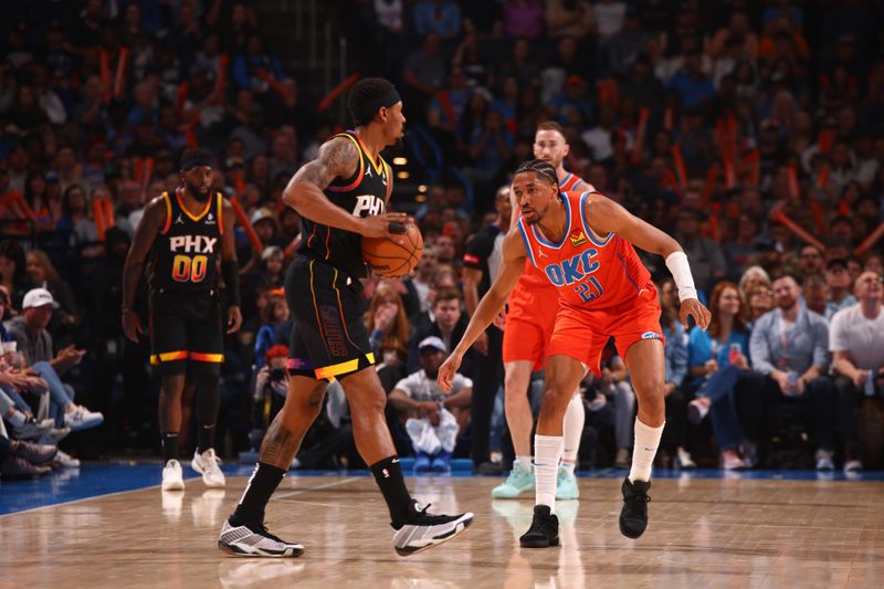 OKLAHOMA CITY, OK - MARCH 29: Aaron Wiggins #21 of the Oklahoma City Thunder plays defense against the Phoenix Suns on March 29, 2024 at Paycom Arena in Oklahoma City, Oklahoma. NOTE TO USER: User expressly acknowledges and agrees that, by downloading and or using this photograph, User is consenting to the terms and conditions of the Getty Images License Agreement. Mandatory Copyright Notice: Copyright 2024 NBAE (Photo by Zach Beeker/NBAE via Getty Images)