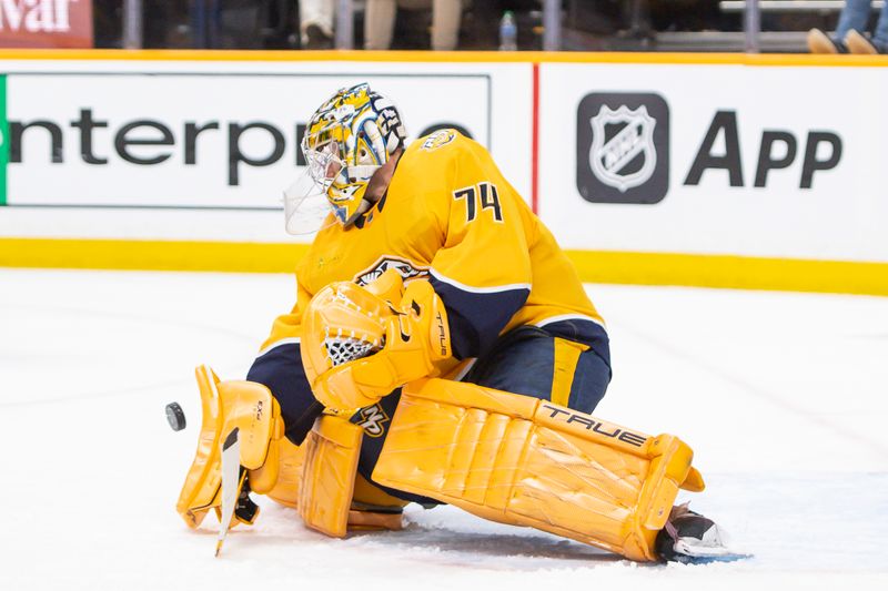 Feb 13, 2024; Nashville, Tennessee, USA;  Nashville Predators goaltender Juuse Saros (74) blocks a puck against the New Jersey Devils during the second period at Bridgestone Arena. Mandatory Credit: Steve Roberts-USA TODAY Sports