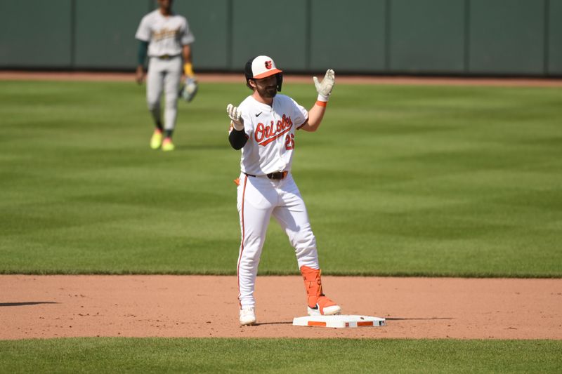 Apr 28, 2024; Baltimore, Maryland, USA;  Baltimore Orioles center fielder Ryan McKenna (26) reacts after reaching second base on a throwing error during the seventh inning against the Oakland Athletics at Oriole Park at Camden Yards. Mandatory Credit: James A. Pittman-USA TODAY Sports