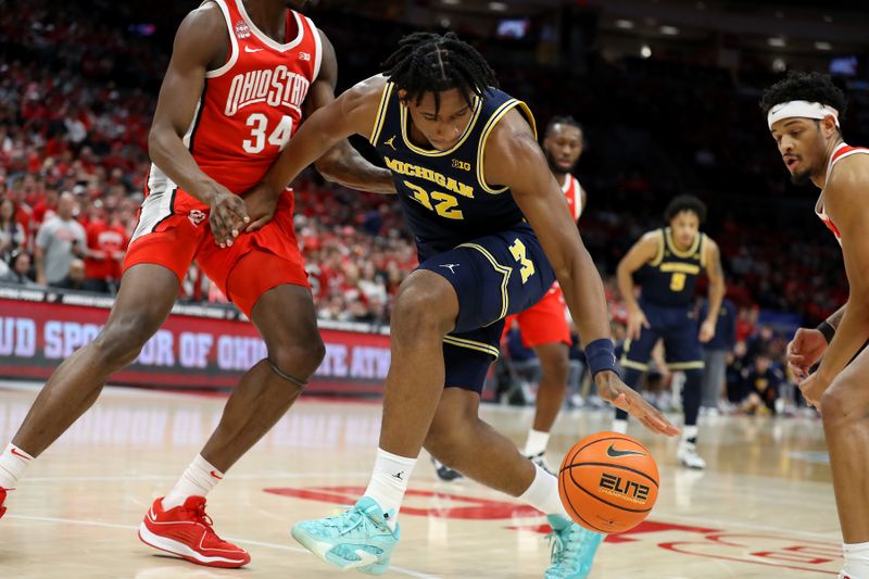 Mar 3, 2024; Columbus, Ohio, USA; Michigan Wolverines forward Tarris Reed Jr. (32) loses the ball as Ohio State Buckeyes center Felix Okpara (34) defends during the first half at Value City Arena. Mandatory Credit: Joseph Maiorana-USA TODAY Sports