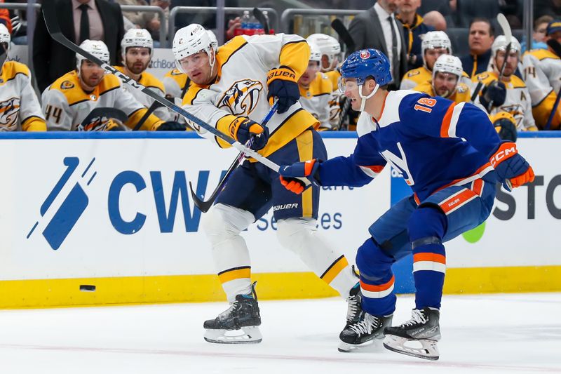 Apr 6, 2024; Elmont, New York, USA; Nashville Predators defenseman Luke Schenn (2) moves the puck past New York Islanders left wing Pierre Engvall (18) during the first period at UBS Arena. Mandatory Credit: Tom Horak-USA TODAY Sports