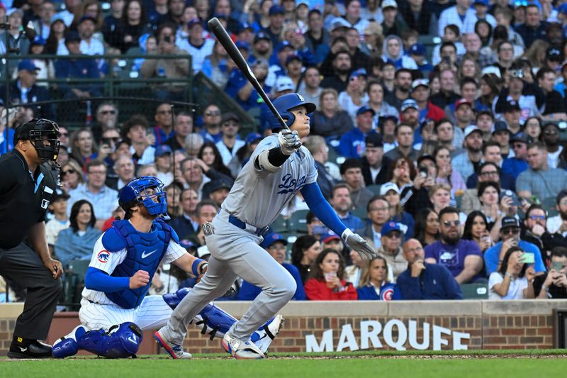 Apr 23, 2025; Chicago, Illinois, USA;  Los Angeles Dodgers two-way player Shohei Ohtani (17) singles during the third inning against the Chicago Cubs at Wrigley Field. Mandatory Credit: Matt Marton-Imagn Images