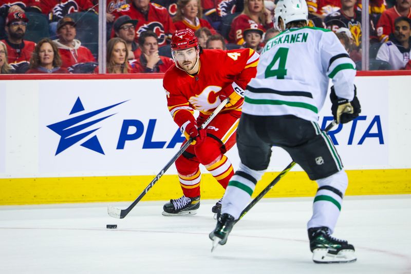 Nov 30, 2023; Calgary, Alberta, CAN; Calgary Flames defenseman Rasmus Andersson (4) controls the puck against the Dallas Stars during the overtime period at Scotiabank Saddledome. Mandatory Credit: Sergei Belski-USA TODAY Sports