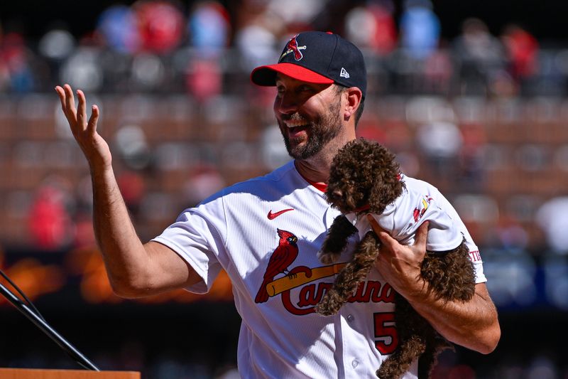 Oct 1, 2023; St. Louis, Missouri, USA;  St. Louis Cardinals starting pitcher Adam Wainwright (50) reacts after receiving a puppy from the St. Louis Cardinals organization as a retirement gift during his retirement ceremony before a game against the Cincinnati Reds at Busch Stadium. Mandatory Credit: Jeff Curry-USA TODAY Sports