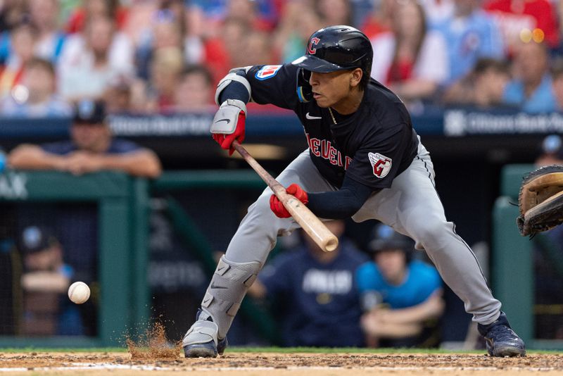 Jul 26, 2024; Philadelphia, Pennsylvania, USA; Cleveland Guardians catcher Bo Naylor (23) hits an RBI sacrifice bunt during the fourth inning against the Philadelphia Phillies at Citizens Bank Park. Mandatory Credit: Bill Streicher-USA TODAY Sports