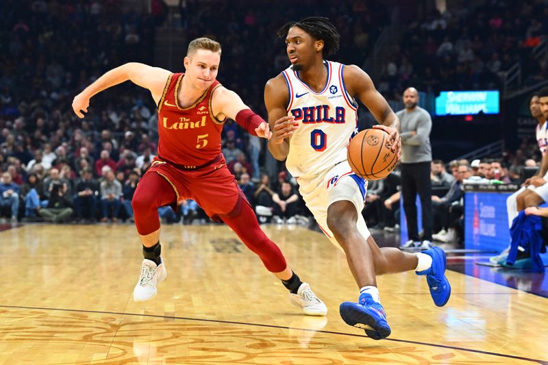 CLEVELAND, OHIO - FEBRUARY 12: Tyrese Maxey #0 of the Philadelphia 76ers drives to the basket around Sam Merrill #5 of the Cleveland Cavaliers during the second quarter at Rocket Mortgage Fieldhouse on February 12, 2024 in Cleveland, Ohio. NOTE TO USER: User expressly acknowledges and agrees that, by downloading and or using this photograph, User is consenting to the terms and conditions of the Getty Images License Agreement. (Photo by Jason Miller/Getty Images)