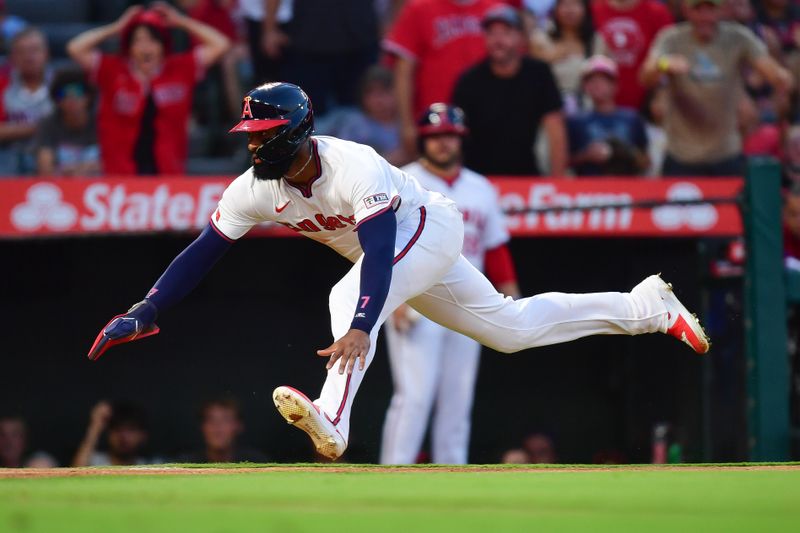 Jul 26, 2024; Anaheim, California, USA; Los Angeles Angels right fielder Jo Adell (7) slides home against the Oakland Athletics during the fifth inning at Angel Stadium. Mandatory Credit: Gary A. Vasquez-USA TODAY Sports