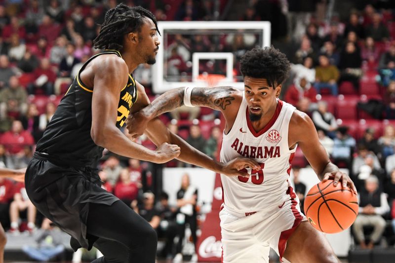 Jan 16, 2024; Tuscaloosa, Alabama, USA; Alabama guard Aaron Estrada drives around Missouri forward Aidan Shaw (23) in their game at Coleman Coliseum. Mandatory Credit: Gary Cosby Jr.-USA TODAY Sports