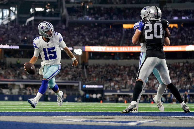 Dallas Cowboys quarterback Will Grier sprints into the end zone, past Las Vegas Raiders safety Isaiah Pola-Mao (20) to score a touchdown in the first half of a preseason NFL football game against the Las Vegas Raiders in Arlington, Texas, Saturday, Aug. 26, 2023. (AP Photo/Sam Hodde)