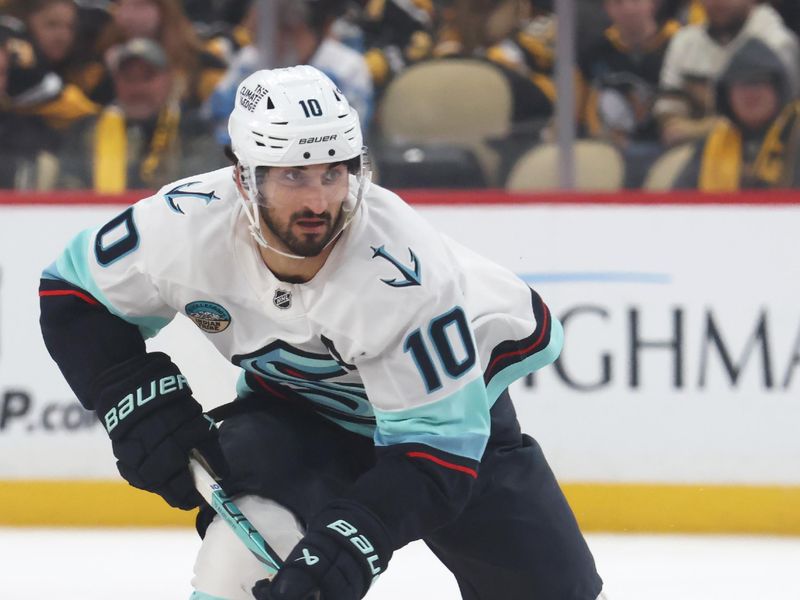 Nov 22, 2025; Pittsburgh, Pennsylvania, USA;  Seattle Kraken center Matty Beniers (10) skates up ice with the puck against the Pittsburgh Penguins during the second period at PPG Paints Arena. Mandatory Credit: Charles LeClaire-Imagn Images