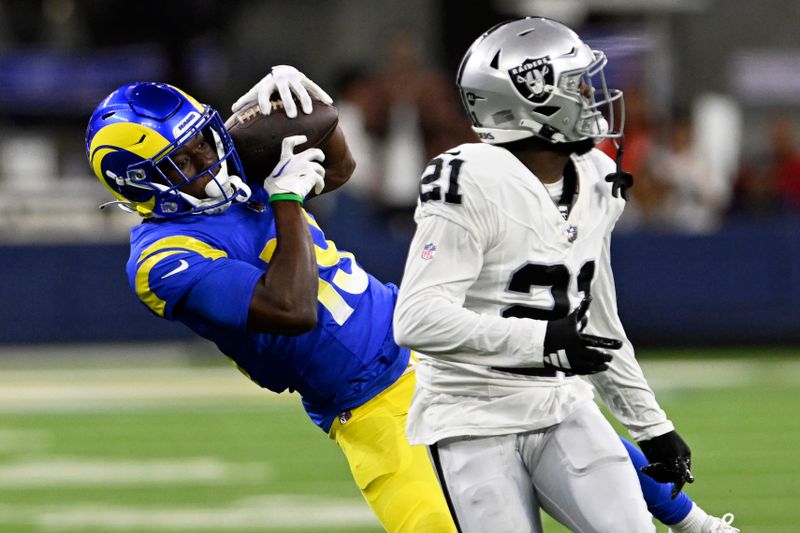 Los Angeles Rams wide receiver Xavier Smith, left, catches a pass behind Las Vegas Raiders cornerback Amik Robertson (21) during the second half of a preseason NFL football game Saturday, Aug. 19, 2023, in Inglewood, Calif. (AP Photo/Alex Gallardo)