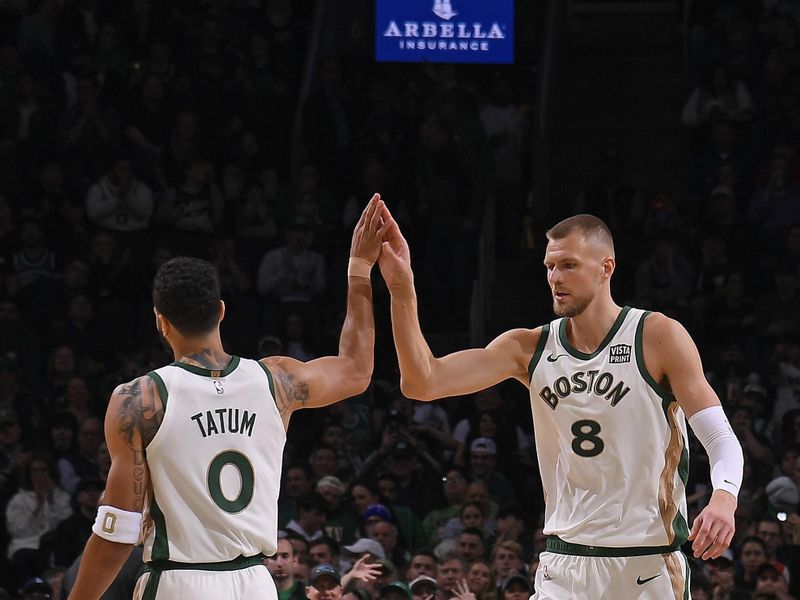 BOSTON, MA - FEBRUARY 27: Kristaps Porzingis #8 and Jayson Tatum #0 of the Boston Celtics high five during the game against the Philadelphia 76ers on February 27, 2024 at the TD Garden in Boston, Massachusetts. NOTE TO USER: User expressly acknowledges and agrees that, by downloading and or using this photograph, User is consenting to the terms and conditions of the Getty Images License Agreement. Mandatory Copyright Notice: Copyright 2024 NBAE  (Photo by Brian Babineau/NBAE via Getty Images)