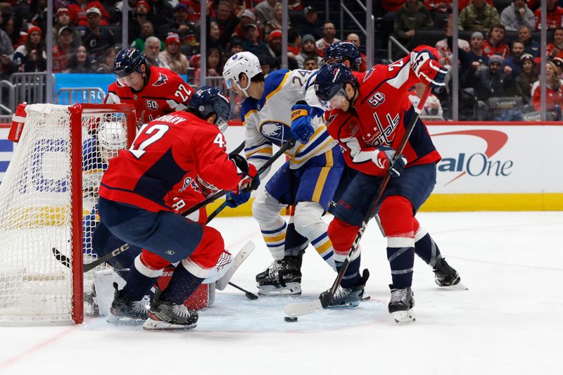 Dec 14, 2024; Washington, District of Columbia, USA; Washington Capitals center Nic Dowd (26) clears the puck from in front of Capitals goaltender Logan Thompson (48) and Buffalo Sabres center Dylan Cozens (24) in the second period at Capital One Arena. Mandatory Credit: Geoff Burke-Imagn Images