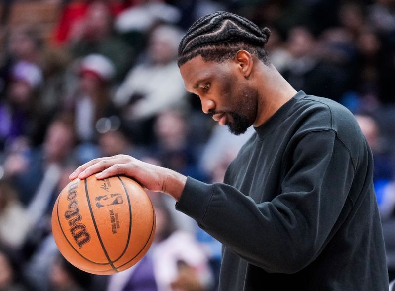 TORONTO, ON - MARCH 31: Joel Embiid #21 of the Philadelphia 76ers, who sat out of the game due to injury, dribbles a ball in a break in play, against Toronto Raptors during the second half of their basketball game at the Scotiabank Arena on March 31, 2024 in Toronto, Ontario, Canada. NOTE TO USER: User expressly acknowledges and agrees that, by downloading and/or using this Photograph, user is consenting to the terms and conditions of the Getty Images License Agreement. (Photo by Mark Blinch/Getty Images)