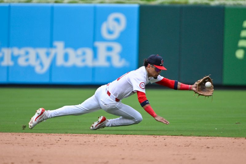 Jul 14, 2024; St. Louis, Missouri, USA;  St. Louis Cardinals shortstop Masyn Winn (0) dives and fields a ground ball against the Chicago Cubs during the ninth inning at Busch Stadium. Mandatory Credit: Jeff Curry-USA TODAY Sports