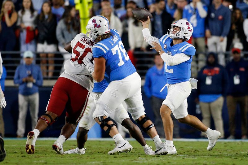 Oct 7, 2023; Oxford, Mississippi, USA; Mississippi Rebels quarterback Jaxson Dart (2) passes the ball as offensive linemen Jeremy James (78) blocks Arkansas Razorbacks defensive linemen Eric Gregory (50) at Vaught-Hemingway Stadium. Mandatory Credit: Petre Thomas-USA TODAY Sports