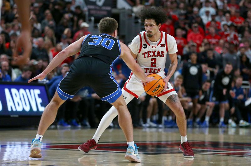 Jan 20, 2024; Lubbock, Texas, USA;  Texas Tech Red Raiders guard Pop Isaacs (2) looks for an opening against Brigham Young Cougars guard Dallin Hall (30) in the second half at United Supermarkets Arena. Mandatory Credit: Michael C. Johnson-USA TODAY Sports