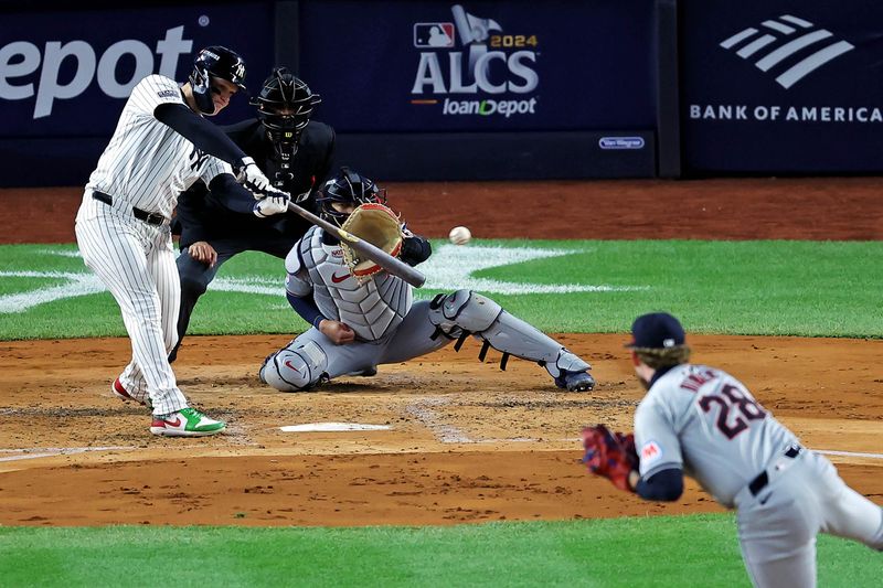 Oct 15, 2024; Bronx, New York, USA; New York Yankees outfielder Alex Verdugo (24) hits an RBI double during the second inning against the Cleveland Guardians in game two of the ALCS for the 2024 MLB Playoffs at Yankee Stadium. Mandatory Credit: Brad Penner-Imagn Images