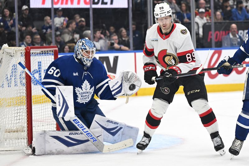 Feb 28, 2026; Toronto, Ontario, CAN;  Toronto Maple Leafs goalie Joseph Woll (60) makes a glove save on an attempted shot deflection by Ottawa Senators forward Lars Eller (89) in the second period at Scotiabank Arena. Mandatory Credit: Dan Hamilton-Imagn Images