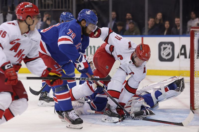 May 13, 2024; New York, New York, USA; Carolina Hurricanes center Jordan Staal (11) scores a goal against New York Rangers goaltender Igor Shesterkin (31) and defenseman K'Andre Miller (79) during the third period of game five of the second round of the 2024 Stanley Cup Playoffs at Madison Square Garden. Mandatory Credit: Brad Penner-USA TODAY Sports