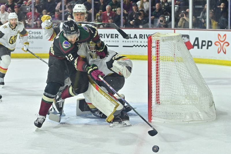 Feb 8, 2024; Tempe, Arizona, USA;  Arizona Coyotes center Jack McBain (22) and Vegas Golden Knights goaltender Adin Hill (33) battle for the puck during the second period at Mullett Arena. Mandatory Credit: Matt Kartozian-USA TODAY Sports