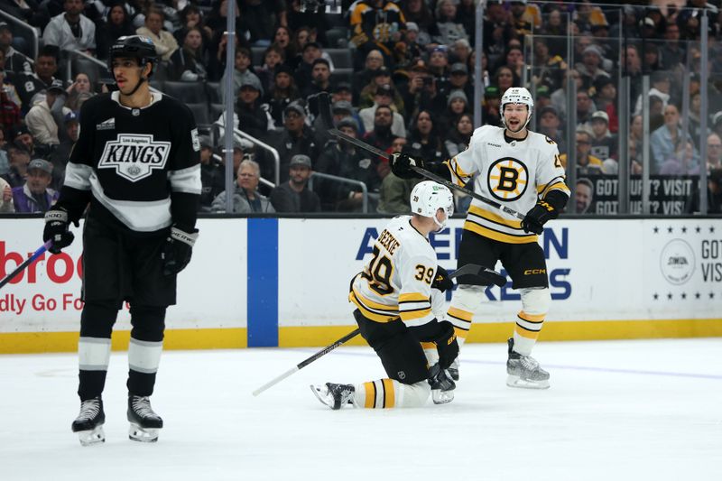 Nov 21, 2025; Los Angeles, California, USA;  Boston Bruins center Morgan Geekie (39) celebrates with center Elias Lindholm (28) after scoring a goal during the third period against the Los Angeles Kings at Crypto.com Arena. Mandatory Credit: Kiyoshi Mio-Imagn Images