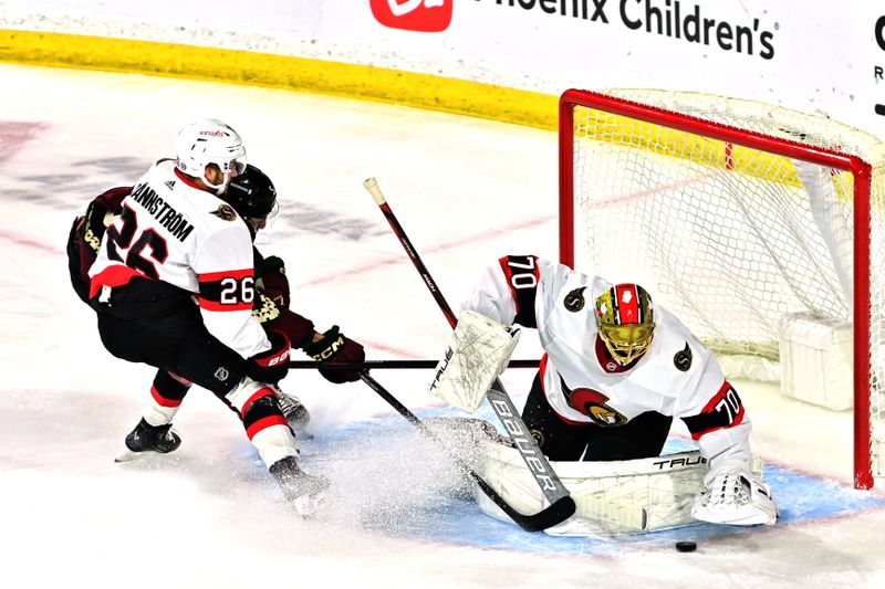 Dec 19, 2023; Tempe, Arizona, USA; Ottawa Senators goaltender Joonas Korpisalo (70) makes a save on Arizona Coyotes defenseman Michael Kesselring (5) as defenseman Erik Brannstrom (26) defends in the first period at Mullett Arena. Mandatory Credit: Matt Kartozian-USA TODAY Sports