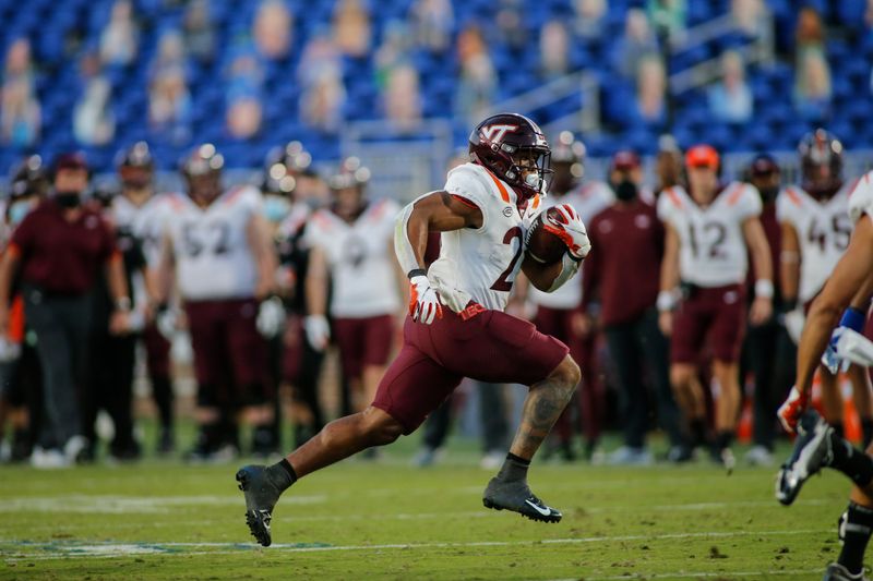 Oct 3, 2020; Durham, North Carolina, USA; Virginia Tech Hokies running back Khalil Herbert (21) breaks free for a touchdown run against the Duke Blue Devils in the second half at Wallace Wade Stadium. The Virginia Tech Hokies won 38-31. Mandatory Credit: Nell Redmond-USA TODAY Sports