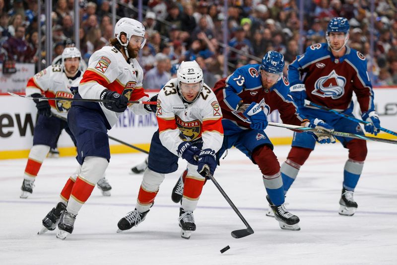 Dec 11, 2025; Denver, Colorado, USA; Florida Panthers center Carter Verhaeghe (23) controls the puck ahead of Colorado Avalanche right wing Valeri Nichushkin (13) as defenseman Aaron Ekblad (5) defends in the second period at Ball Arena. Mandatory Credit: Isaiah J. Downing-Imagn Images