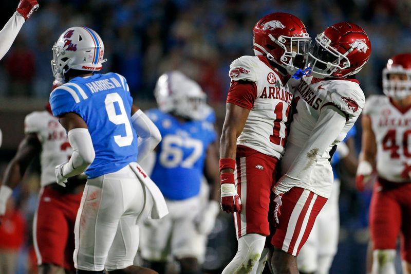 Oct 7, 2023; Oxford, Mississippi, USA; Arkansas Razorbacks defensive backs Jaylon Braxton (11) and  Lorando Johnson (1) react after a pass break up during the first half against the Mississippi Rebels at Vaught-Hemingway Stadium. Mandatory Credit: Petre Thomas-USA TODAY Sports