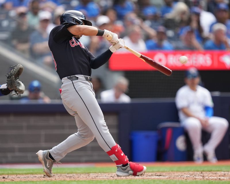 Jun 15, 2024; Toronto, Ontario, CAN; Cleveland Guardians designated hitter Steven Kwan (38) hits a single against the Toronto Blue Jays during the eighth inning at Rogers Centre. Mandatory Credit: Nick Turchiaro-USA TODAY Sports