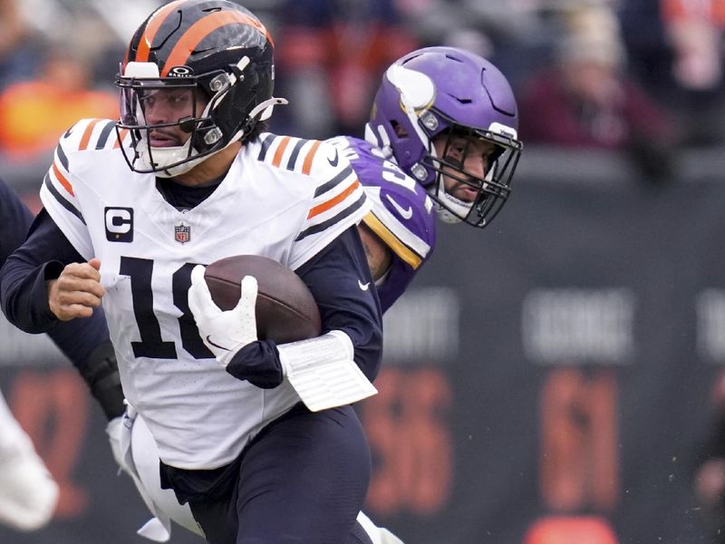 Chicago Bears quarterback Caleb Williams (18) runs out of the pocket during the second half of an NFL football game against the Minnesota Vikings, Sunday, Nov. 24, 2024, in Chicago. (AP Photo/Erin Hooley)