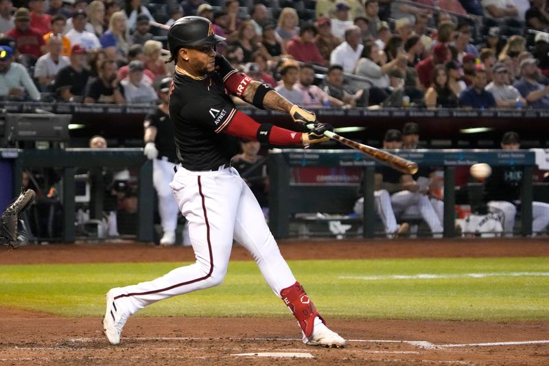 May 28, 2023; Phoenix, Arizona, USA; Arizona Diamondbacks second baseman Ketel Marte (4) hits a single against the Boston Red Sox in the fifth inning at Chase Field. Mandatory Credit: Rick Scuteri-USA TODAY Sports