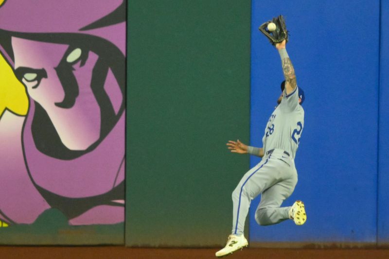 Aug 27, 2024; Cleveland, Ohio, USA; Kansas City Royals center fielder Kyle Isbel (28) makes a leaping catch in the ninth inning against the Cleveland Guardians at Progressive Field. Mandatory Credit: David Richard-USA TODAY Sports