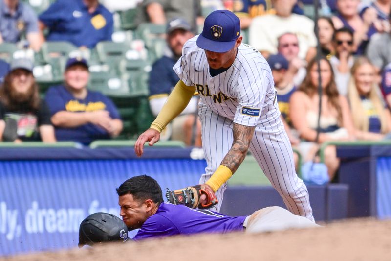 Sep 8, 2024; Milwaukee, Wisconsin, USA;  Milwaukee Brewers third baseman Joseph Ortiz (3) tags out Colorado Rockies shortstop Ezequiel Tovar (14) trying to advance to third base on a flyball in the fifth inning at American Family Field. Mandatory Credit: Benny Sieu-Imagn Images