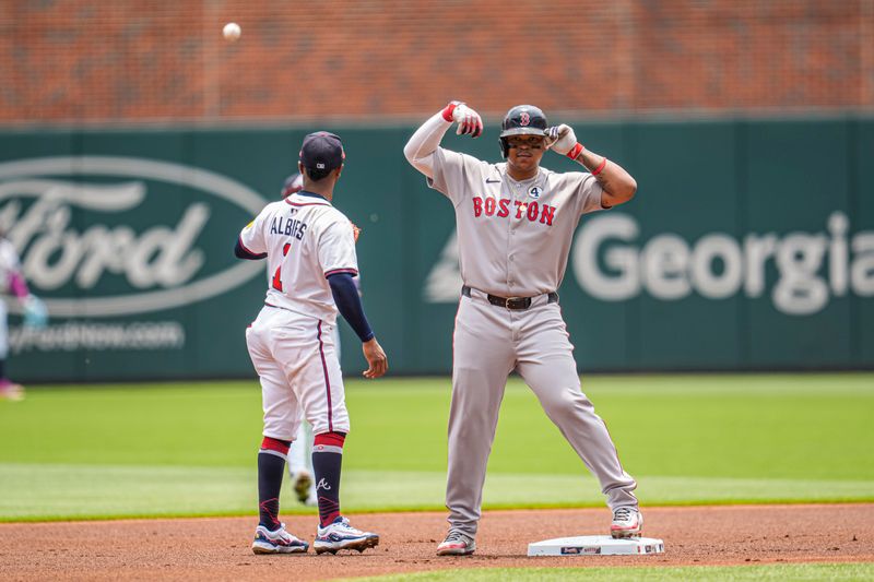 Jun 1, 2025; Cumberland, Georgia, USA; Boston Red Sox designated hitter Rafael Devers (11) reacts after hitting a double against the Atlanta Braves during the first inning at Truist Park. Mandatory Credit: Dale Zanine-Imagn Images