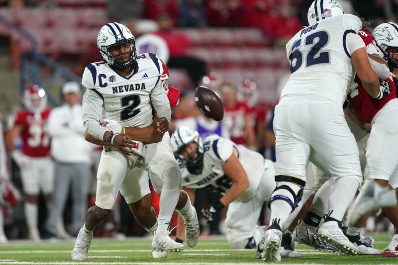 Sep 30, 2023; Fresno, California, USA; Nevada Wolf Pack quarterback Brendon Lewis (2) fumbles the ball after being hit by Fresno State Bulldogs defensive lineman Jacob Holmes (23) in the fourth quarter at Valley Children's Stadium. Mandatory Credit: Cary Edmondson-USA TODAY Sports