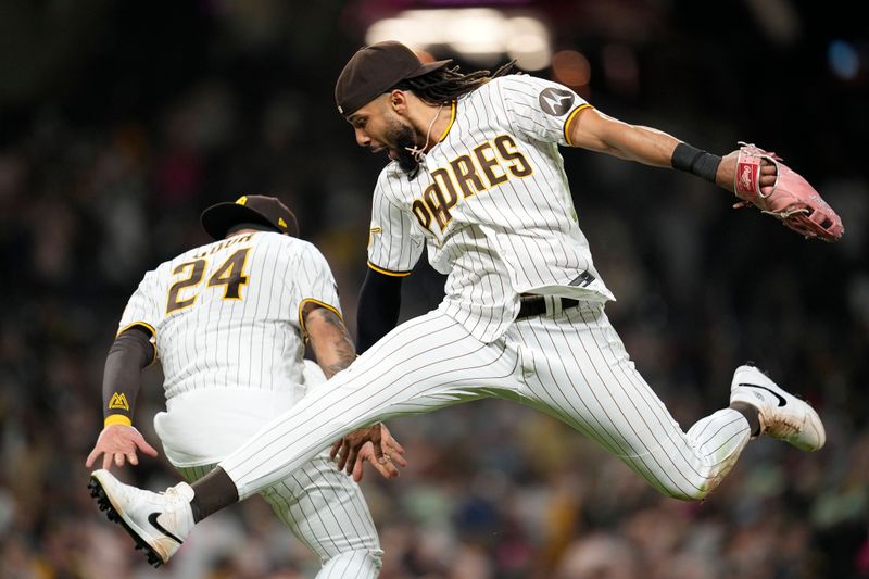 Jun 14, 2023; San Diego, California, USA;  San Diego Padres right fielder Fernando Tatis Jr. (right) celebrates with second baseman Rougned Odor (24) after defeating the Cleveland Guardians at Petco Park. Mandatory Credit: Ray Acevedo-USA TODAY Sports