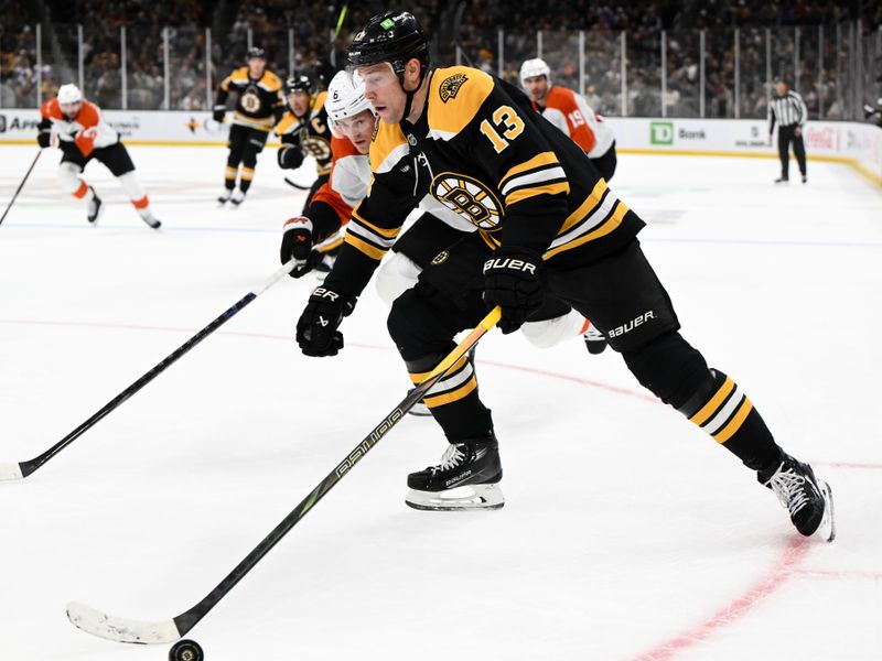 iOct 29, 2024; Boston, Massachusetts, USA; Boston Bruins center Charlie Coyle (13) skates with the puck against Philadelphia Flyers defenseman Travis Sanheim (6) during the first period at TD Garden. Mandatory Credit: Brian Fluharty-Imagn Images