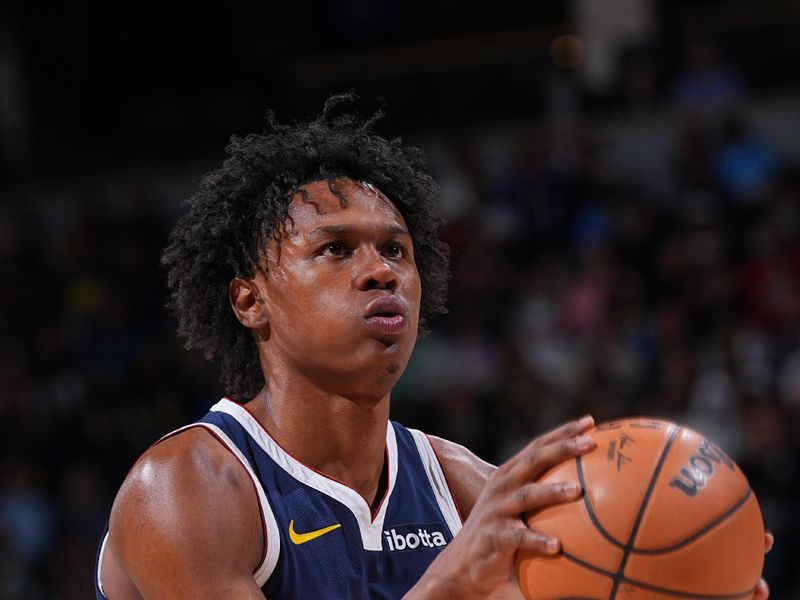 DENVER, CO - MARCH 25: Peyton Watson #8 of the Denver Nuggets shoots a free throw during the game against the Memphis Grizzlies on March 25, 2024 at the Ball Arena in Denver, Colorado. NOTE TO USER: User expressly acknowledges and agrees that, by downloading and/or using this Photograph, user is consenting to the terms and conditions of the Getty Images License Agreement. Mandatory Copyright Notice: Copyright 2024 NBAE (Photo by Bart Young/NBAE via Getty Images)