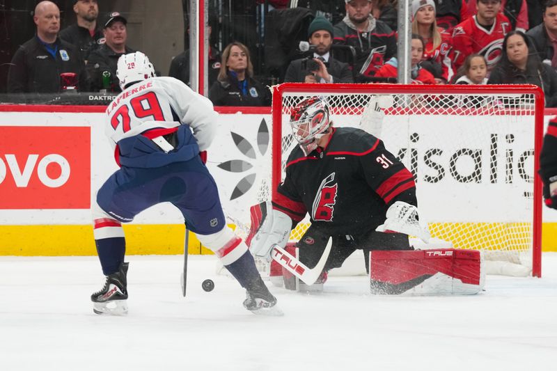 Nov 11, 2025; Raleigh, North Carolina, USA;  Carolina Hurricanes goaltender Frederik Andersen (31) stops the shot attempt by Washington Capitals center Hendrix Lapierre (29) during the first period at Lenovo Center. Mandatory Credit: James Guillory-Imagn Images