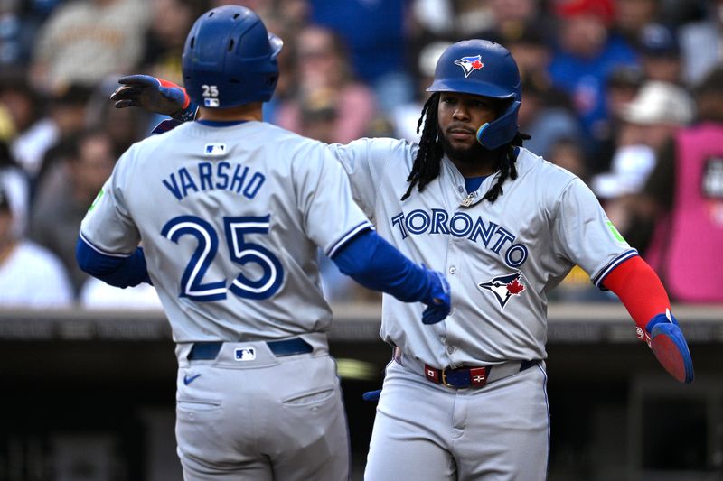 Apr 20, 2024; San Diego, California, USA; Toronto Blue Jays left fielder Daulton Varsho (25) is congratulated by first baseman Vladimir Guerrero Jr. (right) after hitting a three-run home run against the San Diego Padres during the first inning at Petco Park. Mandatory Credit: Orlando Ramirez-USA TODAY Sports