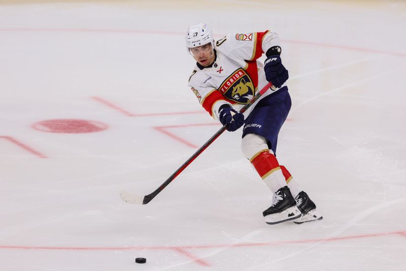 Mar 21, 2024; Sunrise, Florida, USA; Florida Panthers center Evan Rodrigues (17) moves the puck against the Nashville Predators during the third period at Amerant Bank Arena. Mandatory Credit: Sam Navarro-USA TODAY Sports