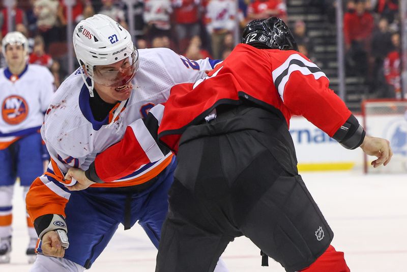 Nov 28, 2023; Newark, New Jersey, USA; New York Islanders left wing Anders Lee (27) and New Jersey Devils defenseman Brendan Smith (2) fight during the third period at Prudential Center. Mandatory Credit: Ed Mulholland-USA TODAY Sports