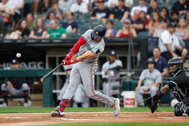 Jul 8, 2024; Chicago, Illinois, USA; Minnesota Twins outfielder Trevor Larnach (9) hits a solo home run against the Chicago White Sox during the first inning at Guaranteed Rate Field. Mandatory Credit: Kamil Krzaczynski-USA TODAY Sports